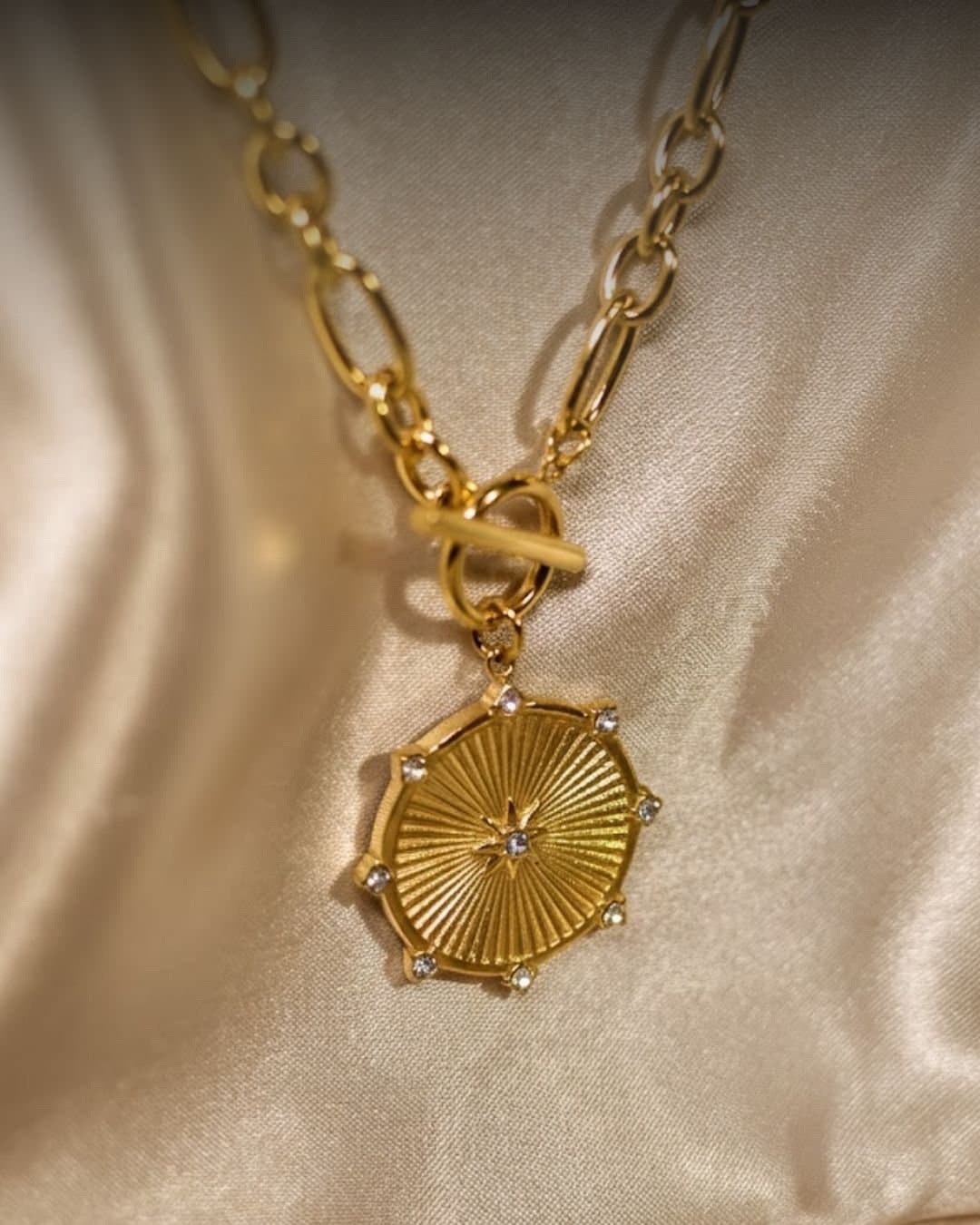 Golden radial sunburst pendant with chunky link chain